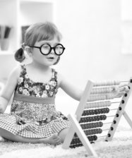 girl with glasses playing the abacus toy